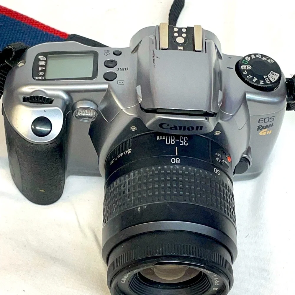 Canon EOS Rebel GII 35mm SLR Camera - Silver & Black with shoulder strap